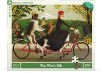 New York Puzzle Company Puzzel Miss Moon's Bike - 1000 stukjes